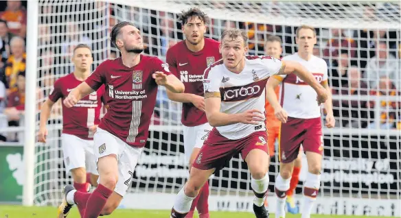  ?? ?? Matt Grimes of Northampto­n Town competes with Charlie Wyke of Bradford City during Bradford’s 1-0 win in League One yesterday