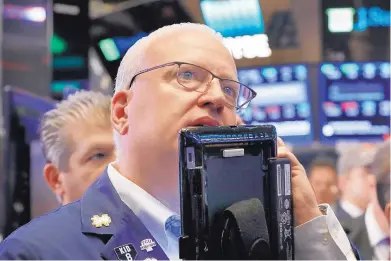  ?? ASSOCIATED PRESS FILE ?? Trader Thomas Ferrigno works on the floor of the New York Stock Exchange. Stocks reached their biggest gain in six months on Tuesday after strong earnings reports from financial and health care companies.