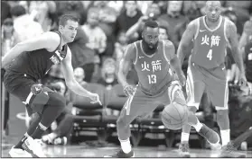  ?? AP/MICHAEL WYKE ?? Rockets guard James Harden (13) chases down the ball in front of Minnesota forward Nemanja Bjelica (left) on Friday in Houston.