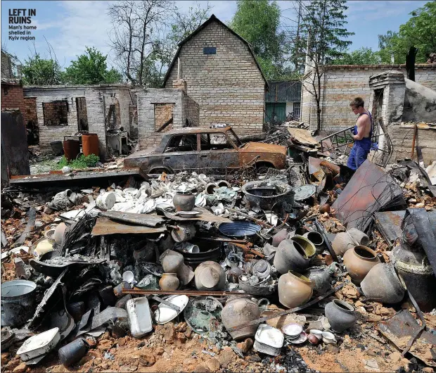  ?? ?? LEFT IN RUINS Man’s home shelled in Kyiv region