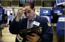  ?? RICHARD DREW — THE ASSOCIATED PRESS ?? Trader Tommy Kalikas works on the floor of the New York Stock Exchange, Monday.