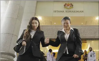  ?? — Bernama photo ?? Nik Elin Zurina (right) and Tengku Yasmin seen on their way out of the Palace of Justice.