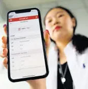  ?? AP ?? In this July 30, 2019 photo, Lee Kyung Eon, 26, holds her mobile phone showing her cancelled status on a Japan-bound plane during an interview in Bundang, South Korea.