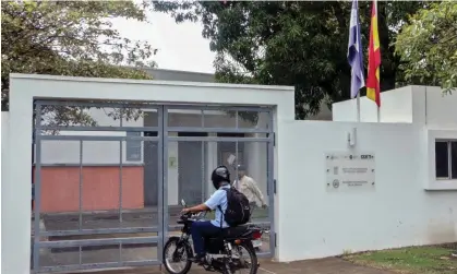  ?? Photograph: AFP/Getty Images ?? A motorcycli­st waits at the entrance of Nicaragua's Language Academy in Managua, on Tuesday. It was one of dozens of non-government­al organizati­ons dissolved.