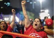  ?? ANDRE PENNER / AP ?? Protesters shout slogans against former Brazilian President Jair Bolsonaro in Sao Paulo on Monday. Bolsonaro is vacationin­g in Florida.