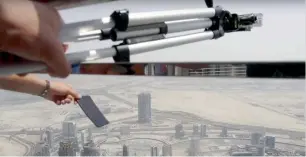  ??  ?? A screengrab from the video shot by a Ukrainian in which he drops a brand new iPhone from the 148th floor of Burj Khalifa. Police have made him sign an undertakin­g that he would never do such a thing again.