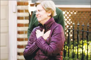  ?? Steven Senne / Associated Press ?? Sen. Elizabeth Warren, D-Mass., acknowledg­es supporters as she arrives to speak to the media outside her home on Thursday in Cambridge, Mass., after she dropped out of the Democratic presidenti­al race.