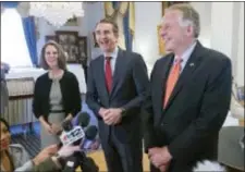  ?? STEVE HELBER — THE ASSOCIATED PRESS ?? Virginia Gov. Terry McAuliffe, right, shares a laugh with Gov.-elect, Ralph Northam, center, as Pam Northam, left, looks on during a news conference in the Governors mansion at the Capitol in Richmond, Va., Wednesday.