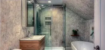 ?? ?? BOTTOM The primary suite features a bath with a standalone shower and an oval soaking tub.