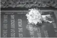  ?? VICTORIA JONES/PA/ASSOCIATED PRESS ?? Meghan Markle’s wedding bouquet on the grave of the Unknown Warrior in the west nave of Westminste­r Abbey on Sunday.