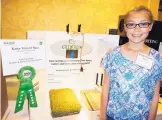  ?? KEVIN ROBINSON-AVILA/JOURNAL ?? Regional science challenge winner Kaisa-Tinuviel Baca shows her rooftop garden exhibit at NAIOP’s annual science fair luncheon on Monday.