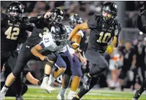  ?? DAVID BECKER/ ?? Faith Lutheran’s Taimani McKenzie returns a Shadow Ridge fumble 36 yards for a touchdown during the third quarter, helping the No. 10 Crusaders to a 37-6 victory in a Northwest League game Friday at Faith Lutheran.