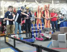  ?? Photos by Ernest A. Brown ?? Above, the Burrillvil­le Renegade team, from left, Andrew Lacouture, Andrew Godfrin, and Seth Kamer, compete in the First Tech Challenge at New England Tech in Warwick on Saturday. Below, Lincoln High School students, from left, Jared Wyankee, Ryan...