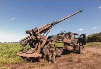  ?? David Guttenfeld­er/New York Times ?? A Ukrainian soldier mans an artillery unit Thursday in Zaporizhzh­ia region. U.S. officials and military analysts say cluster munitions may not have an immediate impact on the war.