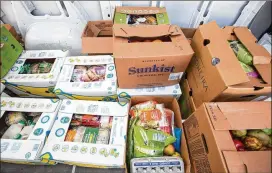  ??  ?? Trader Joe’s and Sprouts donations fill the Second Helpings Atlanta van Tuesday with food that can no longer be sold. It was being taken to the Atlanta Mission.