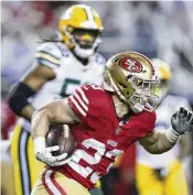  ?? JED JACOBSOHN / AP ?? San Francisco 49ers running back Christian McCaffrey carries during the first half of a divisional-round playoff game last weekend against the Green Bay Packers. McCaffrey scored twice in a 24-21 win.