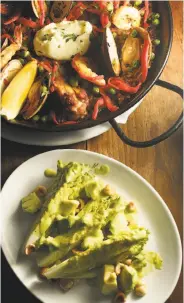  ?? Liz Hafalia / The Chronicle ?? The Little Gem salad with avocados (foreground) and paella, among the best you’ll find.
