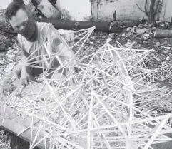  ?? EDD GUMBAN ?? A man makes frames for Christmas lanterns in Plaza Quezon in Las Piñas yesterday.