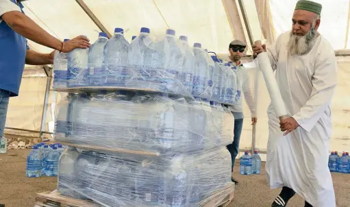  ?? PICTURE: PABALLO THEKISO ?? LIQUID GOLD: Volunteers at the Operation Hydrate centre in Fordsburg, Joburg, pack water to be distribute­d to areas affected by the drought. The group, yesterday, vowed on World Water Day to continue their humanitari­an efforts.