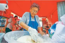  ??  ?? Mary Levi on Thursday mixes dough for frybread that will be used to make Navajo tacos at El Sabor de Nuevo Mexico food stand during Fiesta de Santa Fe.