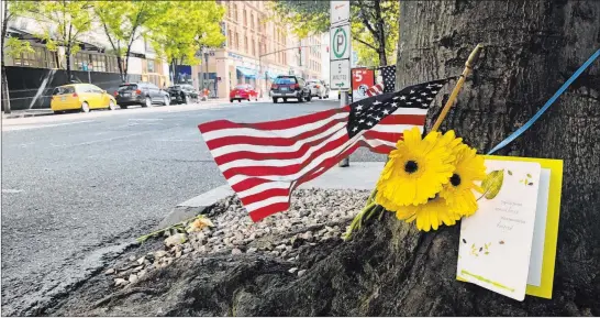  ?? Gillian Flaccus The Associated Press ?? A small memorial pays tribute to shooting victim Aaron Danielson, 39, of Portland at the site where he was killed on Saturday.