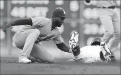  ?? RICHARD W. RODRIGUEZ/TRIBUNE NEWS SERVICE ?? Oakland Athletics second baseman Jurickson Profar, left, tags out the Texas Rangers' Delino DeShields on a steal attempt on Friday in Arlington, Texas.