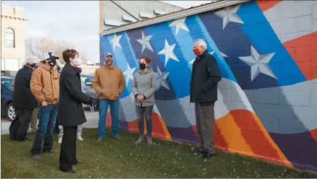  ?? Donnis Hueftle-Bullock ?? First stop on the tour of Ansley with the Lt. Governor is the mural of the American flag. From left are Lance Bristol, Trent Fecht, Chairman of the Board Lanette Doane, Brian and Heidi Beaumont and Lt. Gov. Foley.