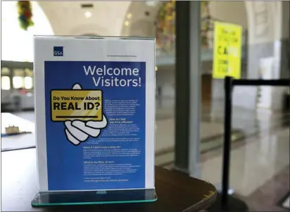  ?? ASSOCIATED PRESS ?? In this file photo, a sign at the federal courthouse in Tacoma, Wash., is shown to inform visitors of the federal government’s REAL ID act, which requires state driver’s licenses and ID cards to have security enhancemen­ts and be issued to people who can prove they’re legally in the United States.