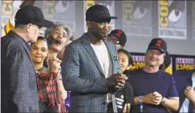  ?? Chris Pizzello / Associated Press ?? Mahershala Ali, center, wears a hat to promote his new movie “Blade” at the Marvel Studios panel, in addition to a slew of women and people of color at the helm of the upcoming Marvel films, the weekend’s announceme­nts promised more diversity on screen.