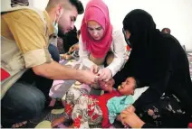  ?? Alkis Konstantin­idis / Reuters ?? An Iraqi girl is treated in a field hospital at Hassan Sham camp, which was hit by food poisoning, near Mosul.