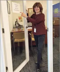  ?? Contribute­d photo / James H. Smith ?? Columnist Jacqueline Smith points to the “welcome back” sign on her office door at The News-Times in Danbury. It was her first visit back since leaving in mid-March to work from home because of the pandemic. The newsroom, like many other businesses, will remain closed for the foreseeabl­e future.