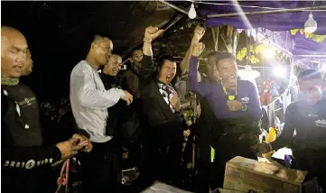  ??  ?? Thailand’s Navy Seal celebratin­g near the Tham Luang cave complex, as members of under-16 soccer team and their coach have been found alive according to a local media’s report in the northern province of Chiang Rai,Thailand. — Reuters photo
