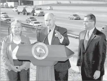  ?? Rich Pedroncell­i Associated Press ?? GOV. JERRY BROWN, center, with Air Resources Board Chairwoman Mary Nichols and Atty. Gen. Xavier Becerra, called President Trump a “one-man demolition derby” against efforts to prevent climate change.