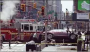  ??  ?? Investigat­ors look under a smashed car that sits on the corner of Broadway and 45th Street in New York’s Times Square after ploughing through a crowd of pedestrian­s at lunchtime on Thursday.