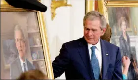  ??  ?? Former President George W. Bush and former first lady Laura Bush, right, unveil their portraits at the White House on Thursday.