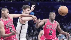  ??  ?? NEW YORK: Chicago Bulls forward Cristiano Felicio (6) guard Jerian Grant (2) and Brooklyn Nets center Brook Lopez fight for a rebound during the first half of an NBA basketball game, Saturday, in New York. —AP