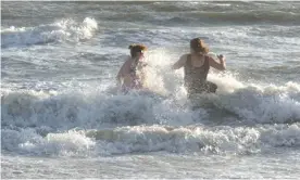  ?? Photograph: Catch Tilly ?? Catch and her daughter Morgan Tilly in the waves at Semaphore Beach in Adelaide. Morgan, who is autistic, has a need to be in the water. When coronaviru­s restrictio­ns came in, she could no longer go to public swimming pools.