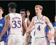  ?? Tim Aylen/Associated Press ?? Kansas’ Gradey Dick, right, who scored 25 points, celebrates with Zuby Ejiofor in Wednesday’s win.