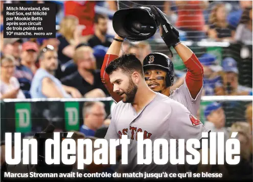  ??  ?? Mitch Moreland, des Red Sox, est félicité par Mookie Betts après son circuit de trois points en 10e manche. PHOTO AFP