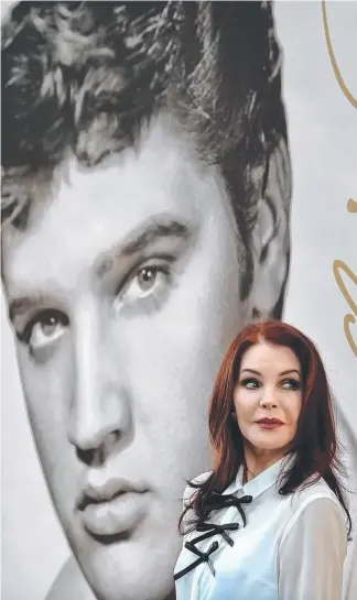 ?? Picture: JIM WEBER/AP ?? Priscilla Presley stands in front of an image of her late husband Elvis.