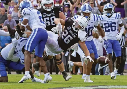  ?? DAVID BANKS/AP ?? Duke defensive back Jaylen Stinson (2) forces Northweste­rn running back Evan Hull (26) to fumble into the end zone on the Wildcats’ final drive Saturday.