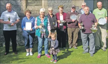  ??  ?? SILVERWARE: St Oran’s flower show prizewinne­rs with their trophies