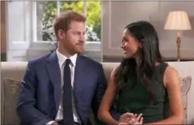  ?? POOL VIA AP ?? In this photo taken from video Britain’s Prince Harry and Meghan Markle talk about their engagement during an interview in London, Monday.