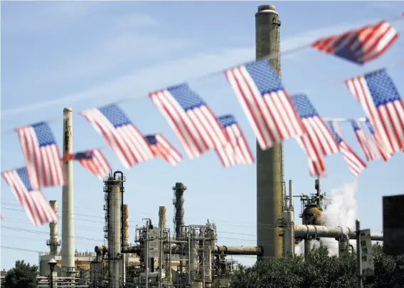  ?? Ben Margot / Associated Press 2008 ?? California gets more than 27 percent of its electricit­y from renewable resources, and refineries like this one in Martinez are subject to a cap-and-trade program.