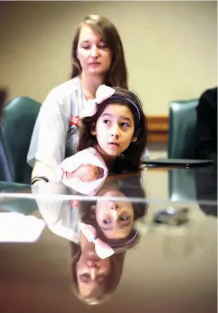  ?? Associated Press ?? Libby Gonzales, a transgende­r girl, sits with her mother Rachel on Wednesday during a news conference held by opponents of a “bathroom bill” at the Texas State Capitol in Austin. Texas House is considerin­g a bill that’s different than one that sparked...