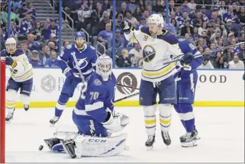  ?? Chris O’meara / Associated Press ?? Buffalo center Zemgus Girgensons celebrates after scoring past Tampa Bay goaltender Louis Domingue during the first period. Buffalo couldn’t hold the lead, failing to win its 11th straight.