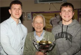  ??  ?? Nicky Cowman making a presentati­on to Ross Daly of Enniscorth­y AC and Padraig Hore of Taghmon AC, joint under-17 county track and field champions, at the Athletics Wexford awards night at Enniscorth­y Rugby Club.