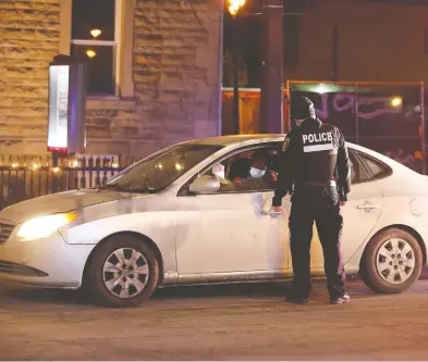  ?? CHRISTINNE MUSCHI / REUTERS FILES ?? Montreal police enforce a curfew imposed to help slow the spread of COVID-19. Criminal defence lawyer Jeffrey Boro
says police interventi­ons should end as soon as a person proves they need to be out during curfew.