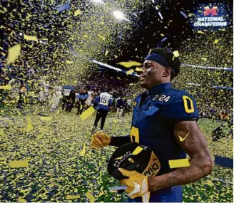  ?? GREGORY SHAMUS/GETTY IMAGES ?? Everett’s Mike Sainristil had a game-sealing intercepti­on, then celebrated amid the confetti as Michigan won its first national title since 1997.