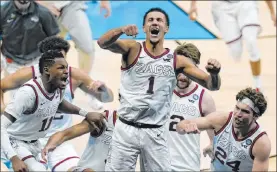  ?? Michael Conroy The Associated Press ?? Gonzaga’s Jalen Suggs (1), rejoicing after his game-winning shot against UCLA on Saturday, is sure to be included in the special video this season.